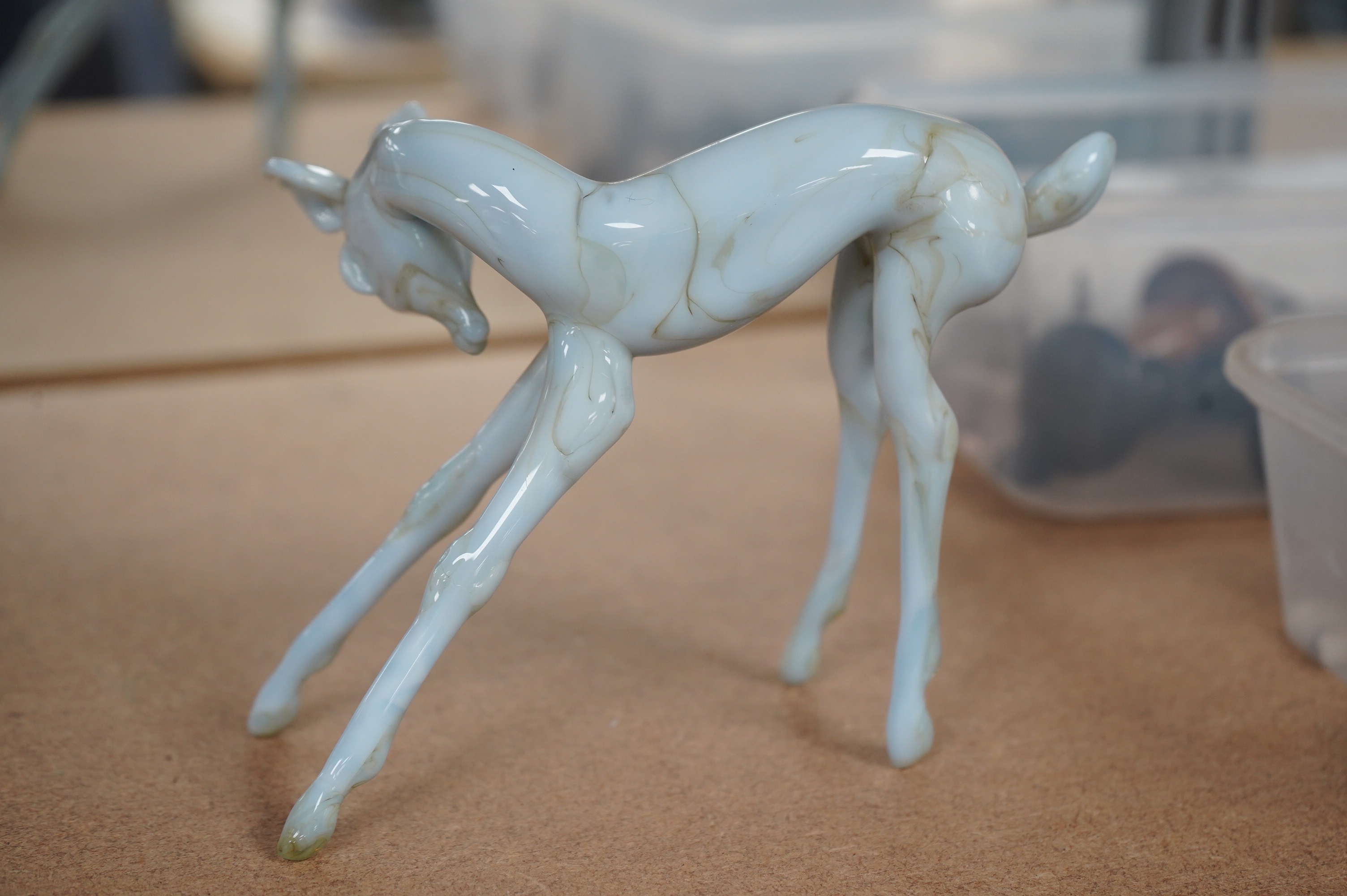 A group of collectables comprising an Istvan Komaromy blue glass foal, 11cm high, three 19th century French faience cows, a South Staffordshire enamel box, a Minton box, eight various seals, a brass thread counter, Condi